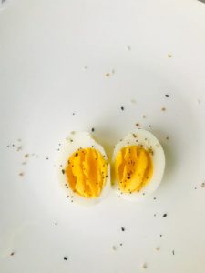 sliced boiled egg on white plate best keto snacks