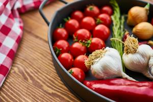 Red Tomatoes and Garlics in Cooking Pot for better health and wellness